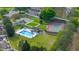 Aerial shot of the community pool and tennis court nestled among mature trees at 2012 Braxton St, Clermont, FL 34711