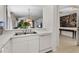 Bright kitchen showcasing a pass-through to the living space, white cabinetry, and modern appliances at 2012 Braxton St, Clermont, FL 34711