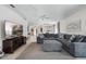 Open-concept living space with cozy sectional sofa, entertainment center, and seamless flow to dining and kitchen areas at 2012 Braxton St, Clermont, FL 34711