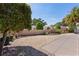 Well-manicured backyard with a decorative brick wall, verdant landscaping, and manicured greenery at 2026 Altamonte Way, The Villages, FL 32162