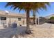 Picturesque backyard showcasing a screened patio, lush palm tree, and a pebble ground cover at 2026 Altamonte Way, The Villages, FL 32162