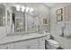 Bright bathroom features granite countertops, large mirror, and a toilet at 2026 Altamonte Way, The Villages, FL 32162