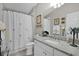 Bathroom with granite countertop, white cabinets, and framed art at 2026 Altamonte Way, The Villages, FL 32162