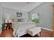 Relaxing bedroom featuring a ceiling fan, bench, and a large window at 2026 Altamonte Way, The Villages, FL 32162