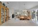 Inviting dining area with stylish chandelier, seamlessly connected to the living space and outdoor patio at 2026 Altamonte Way, The Villages, FL 32162