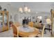 Inviting dining area with stylish chandelier, seamlessly connected to the living space and outdoor space at 2026 Altamonte Way, The Villages, FL 32162