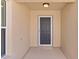 Inviting front entryway featuring a modern door, neutral walls, and a textured floor at 2026 Altamonte Way, The Villages, FL 32162