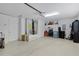 Spacious two car garage with a neutral color palette and bright overhead lighting at 2026 Altamonte Way, The Villages, FL 32162
