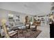 Bright living room featuring neutral décor, comfortable seating, and views of outdoor living space at 2026 Altamonte Way, The Villages, FL 32162