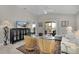 Inviting living room featuring neutral decor, comfortable seating, and access to outdoor space at 2026 Altamonte Way, The Villages, FL 32162