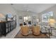 Bright living room featuring neutral décor, comfortable seating, and access to outdoor space at 2026 Altamonte Way, The Villages, FL 32162