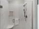 Glass shower with marble-style tiling, handheld sprayer, and a built-in niche at 2026 Altamonte Way, The Villages, FL 32162