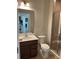 Bathroom featuring single sink vanity, toilet, and glass enclosed tiled shower at 2048 Airedale Way, Lake Alfred, FL 33850