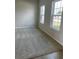 Comfortable bedroom with plush carpeting, bright natural light from two windows, and neutral colored walls at 2048 Airedale Way, Lake Alfred, FL 33850