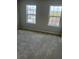 Cozy bedroom with two windows providing ample natural light and plush carpeting at 2048 Airedale Way, Lake Alfred, FL 33850