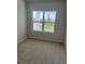 Cozy bedroom filled with natural light from a double window, plush carpeting, and neutral walls at 2048 Airedale Way, Lake Alfred, FL 33850