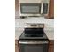 Kitchen appliances: range with glass top, stainless steel microwave at 2048 Airedale Way, Lake Alfred, FL 33850