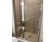 Walk-in shower with tiled walls, glass door, built-in bench, and modern fixtures at 2048 Airedale Way, Lake Alfred, FL 33850