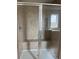 Glass enclosed shower featuring tiled walls, a built-in seat, and chrome fixtures at 2048 Airedale Way, Lake Alfred, FL 33850