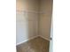 Walk-in closet with plush carpeting and wire shelving for organization at 2048 Airedale Way, Lake Alfred, FL 33850