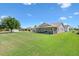 Spacious, lush backyard features a screened-in porch, perfect for enjoying the outdoors at 2104 Iveywood St, The Villages, FL 32163