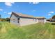 Beautifully maintained home exterior features a spacious backyard and neutral siding under a bright blue sky at 2104 Iveywood St, The Villages, FL 32163