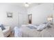 Bright bedroom with light walls, ceiling fan, and ensuite bathroom access at 2104 Iveywood St, The Villages, FL 32163