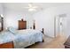 A bedroom with hardwood floors, neutral walls, and a wooden bed at 2104 Iveywood St, The Villages, FL 32163