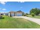 Well-maintained home with a spacious three-car garage and manicured lawn at 2104 Iveywood St, The Villages, FL 32163