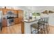 An open kitchen featuring stainless steel appliances and hardwood floors at 2104 Iveywood St, The Villages, FL 32163