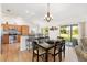 Modern kitchen with stainless steel appliances, breakfast bar, and an adjacent dining area at 2104 Iveywood St, The Villages, FL 32163