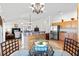 Bright living room with wood floors, a kitchen, dining area, and comfortable furnishings at 2104 Iveywood St, The Villages, FL 32163