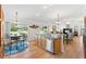 An open living space with dining table, stainless steel appliances, hardwood floors and natural light at 2104 Iveywood St, The Villages, FL 32163