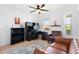 Home office with built-in desk, shelving, plush chair, and natural light at 2104 Iveywood St, The Villages, FL 32163