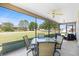 Relaxing screened-in patio with comfortable seating and a peaceful neighborhood view at 2104 Iveywood St, The Villages, FL 32163
