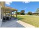 Relaxing screened patio with outdoor seating and serene neighborhood views at 2104 Iveywood St, The Villages, FL 32163