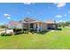 Lovely home with a screened-in lanai, perfect for outdoor entertaining and enjoying the backyard at 2104 Iveywood St, The Villages, FL 32163