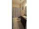 Bathroom with a modern granite vanity, shower and tiled floor at 2129 Amor Way, Leesburg, FL 34748