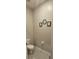 Powder room includes a toilet and wall decor at 2129 Amor Way, Leesburg, FL 34748
