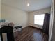 Bedroom with vinyl floors, a large window, and base trim at 2129 Amor Way, Leesburg, FL 34748