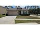 Charming single-Gathering home with a well-maintained lawn and an attached two-car garage at 2129 Amor Way, Leesburg, FL 34748