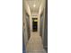 Hallway showcasing tiled flooring and a glimpse into the rooms at 2129 Amor Way, Leesburg, FL 34748