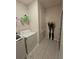Laundry room with tile floors, washer, dryer, shelves and closet at 2129 Amor Way, Leesburg, FL 34748