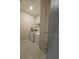 Bright laundry room with washer, dryer, shelving and tile floors at 2129 Amor Way, Leesburg, FL 34748