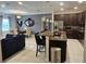 Open-concept living area with kitchen island, dining, and comfortable seating at 2129 Amor Way, Leesburg, FL 34748
