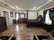 Spacious primary bedroom with wood floors, elegant furniture, and plenty of natural light at 2129 Amor Way, Leesburg, FL 34748