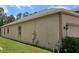 This angle shows the side yard of the home, highlighting the exterior paint and landscaping at 2129 Amor Way, Leesburg, FL 34748