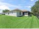 A spacious backyard features a well-maintained lawn and a screened-in porch at 2256 Margarita Dr, The Villages, FL 32159
