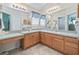 Elegant bathroom with dual sinks, wood cabinets, and ample counter space with great lighting at 2256 Margarita Dr, The Villages, FL 32159