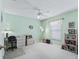 Cozy bedroom featuring carpet, light-green walls, ceiling fan, window, and a desk area at 2256 Margarita Dr, The Villages, FL 32159
